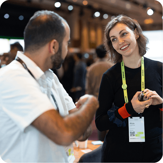 Zendesk Relate attendees have a conversation in the expo hall